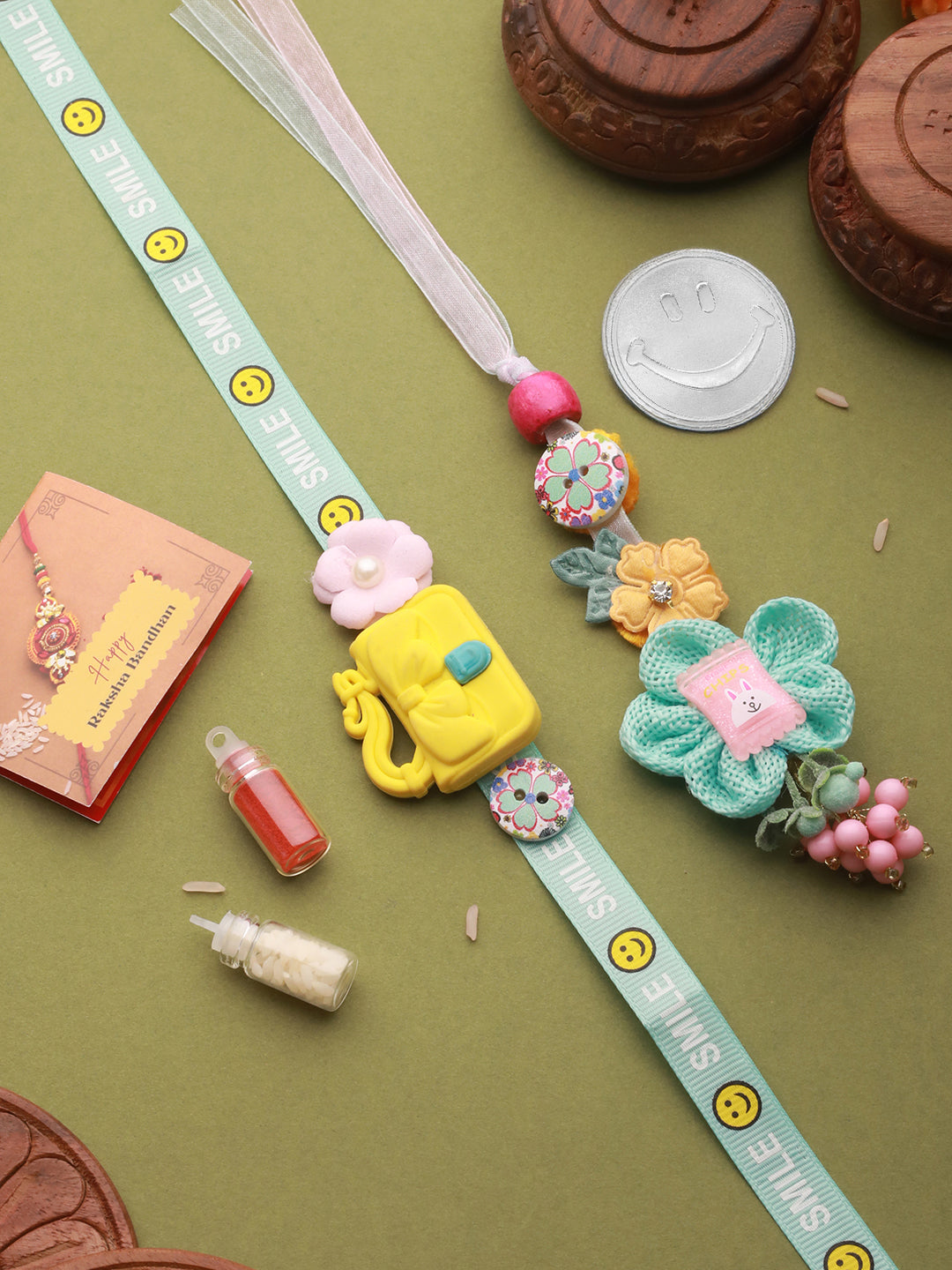 Set Of 2 Cute Handcrafted Ribbon Flower Toy Rakhi Smiley 10 gram 999 Round Silver Coin