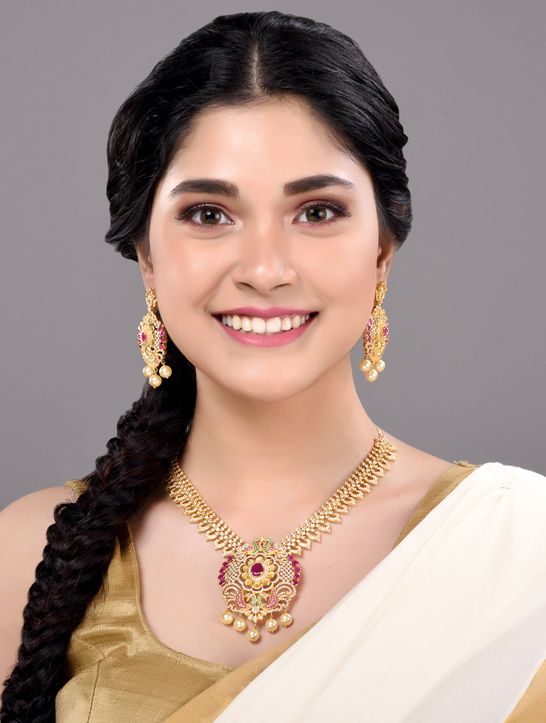 Gold Plated Multi AD & Pearl Studded Hand Crafted Peacock Motif Pendant Necklace Earrings Set
