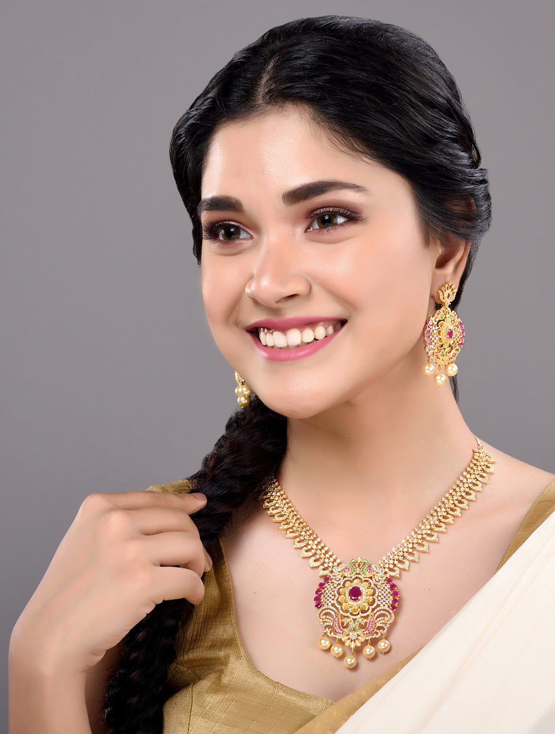 Gold Plated Multi AD & Pearl Studded Hand Crafted Peacock Motif Pendant Necklace Earrings Set